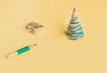 Creative christmas tree. Pencil, shavings and sharpener on a yellow background. Christmas concept in office