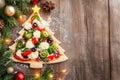 Creative christmas tree shaped pizza on rustic wooden table with festive decorations Royalty Free Stock Photo