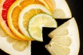 Creative citrus fruits slice on a black background, abstract. lemon, orange, lime, grapefruit, sweetie, pomelo