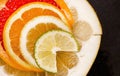 Creative citrus fruits slice on a black background, abstract. lemon, orange, lime, grapefruit, sweetie, pomelo