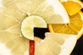 Creative citrus fruits slice on a black background, abstract. lemon, orange, lime, grapefruit, sweetie, pomelo