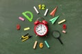 Creative clock face from colorful school supplies on blackboard top view and flat lay. Back to school concept. Royalty Free Stock Photo