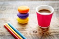 Creative coffee break with macaroon on wooden table