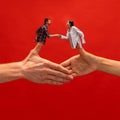 Creative collage with hands. Young man and woman shaking hands symbolizing partnership, agreement and cooperation.