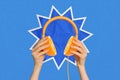 Creative collage picture of hands holding orange slice half headphones headset isolated on blue color background