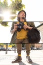 Creative collage. Portrait of young man, photographer, cameraman with professional camera, equipment during working Royalty Free Stock Photo