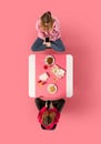 Creative collage. Two young woman, friends sitting at Asian cafe and eating delicious food while speaking against pink Royalty Free Stock Photo