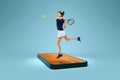Creative collage. Young woman, tennis player in action, motion on 3d phone screen over blue background. Show, games