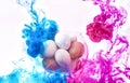 Creative color overflow concept of painting Easter eggs. An explosion of neon colors pink and blue on white background