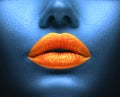 Creative colorful makeup. Bodyart, lipgloss on sexy lips, girls mouth. Orange lips on blue skin