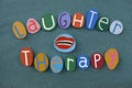 Laughter therapy, a type of complementary therapy also called humor therapy composed with multi colored stone letters and mounth d Royalty Free Stock Photo