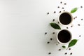 Creative composition cup of coffee with coffee beans and leaf on Royalty Free Stock Photo