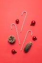 Creative composition with fir cones, red balls on a red background top view. Flat composition for christmas or new year Royalty Free Stock Photo