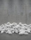 Creative composition of heaps of round skeins of wire on the background of an empty concrete wall. Installation of contemporary