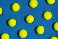 Creative composition made with tennis ball on blue background.