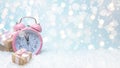 Creative composition with a pink alarm clock and Christmas gift boxes on abstract bokeh background. Minimal Christmas or New Year Royalty Free Stock Photo