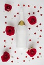 Creative composition with roses, hearts and a bottle of champagne. Valentines or woman's day concept. Minimal flat lay Royalty Free Stock Photo