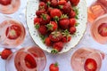 Creative composition with rose wine and delicious strawberries on the white background, top view Royalty Free Stock Photo