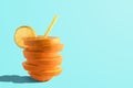 Creative composition with sliced orange and straw on bright background. Minimal fruit concept Royalty Free Stock Photo