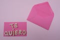 Te quiero, spanish I love you composed with handmade wooden letters over pink card