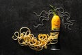 Creative composition with spiral grater and zucchini spaghetti on grey background