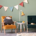Creative composition of stylish and cozy child room interior design with greeen wall, plush toys, furniture and accessories. Royalty Free Stock Photo