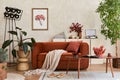 Creative composition of stylish living room interior with mock up poster frame, orange sofa, beige commode, coffee table.