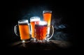 Creative concept. Beer glasses on wooden table at dark toned foggy background Royalty Free Stock Photo