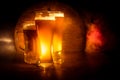 Creative concept. Beer glasses on wooden table at dark toned foggy background Royalty Free Stock Photo