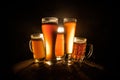 Creative concept. Beer glasses on wooden table at dark toned foggy background Royalty Free Stock Photo