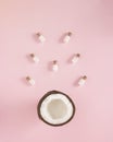 Creative concept of bottles of milk.falls out of fresh coconut. Pastel pink background