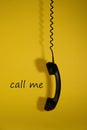 Creative concept of communication. Handset and the inscription `coll me`. Royalty Free Stock Photo