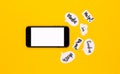 Creative concept of coronavirus mockup. A black telephone lies on a yellow background, next to it are paper message clouds on