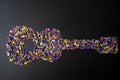 Creative concept of a guitar made of limonium sinuatum flowers, isolated on black Royalty Free Stock Photo