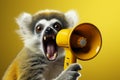 A creative concept, a hilarious lemur wields a yellow attention grabbing loudspeaker Royalty Free Stock Photo