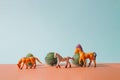 Creative concept made with toy horses and cactus against pastel blue, brown background. Minimal western concept