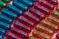 Creative concept with many colorful glitter pills lying in rows diagonally. Minimal style, art concept Royalty Free Stock Photo