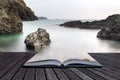 Creative concept pages of book Long exposure Kynance Cove tide Royalty Free Stock Photo