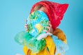 Creative concept plastic bag free. A child closing his face with a painting planet Earth