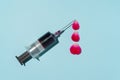 Creative concept syringe with a blood droplets make from rose petal