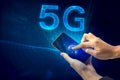 Creative connection background, mobile phone with 5G hologram on the background of the new world era, the concept of 5G network, Royalty Free Stock Photo