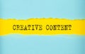 CREATIVE CONTENT text on the torn paper , yellow background