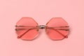 Creative coral trendy sunglasses on pink pastel background