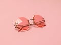 Creative coral trendy sunglasses on pink pastel background