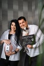 Creative couple with small dog expecting baby, Creative photoshoot for pregnancy, happy family waiting for baby boy Royalty Free Stock Photo