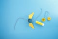 creative craft project on a bright blue background. yellow paper wings attached, A string is threaded through the Royalty Free Stock Photo