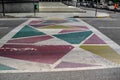 Creative crosswalk with colorful polygons on asphalt in Tirana, Albania
