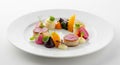 Creative cuisine showcases a delectable dish with scallops, diverse vegetables and elegant presentation on a white plate enhancing Royalty Free Stock Photo