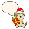 A creative cute cartoon puppy and christmas present and hat and speech bubble in comic book style Royalty Free Stock Photo