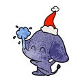 A creative cute textured cartoon of a elephant spouting water wearing santa hat